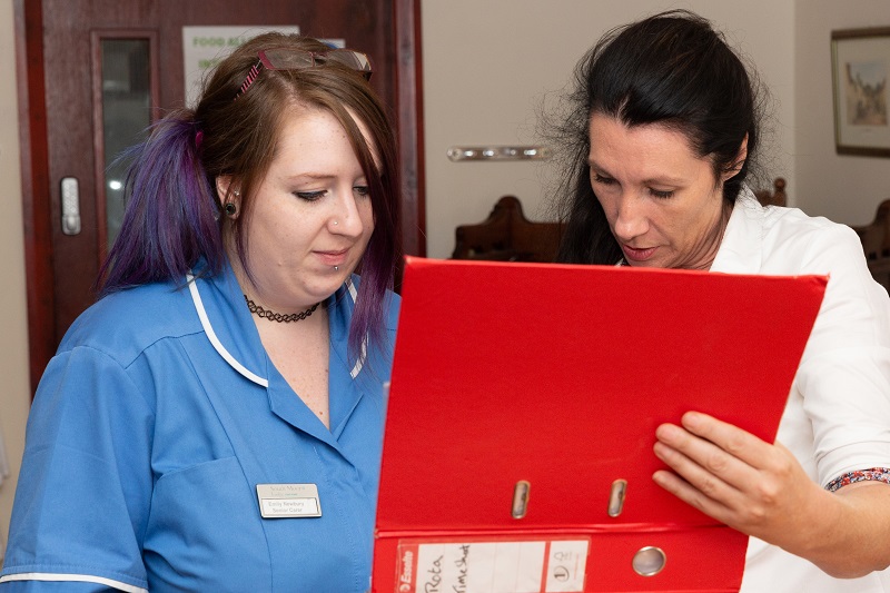 Care staff discussing work towards their Care Home CQC rating