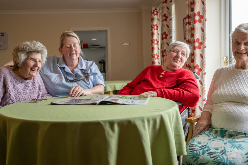 Elderly Residents laughing with carer